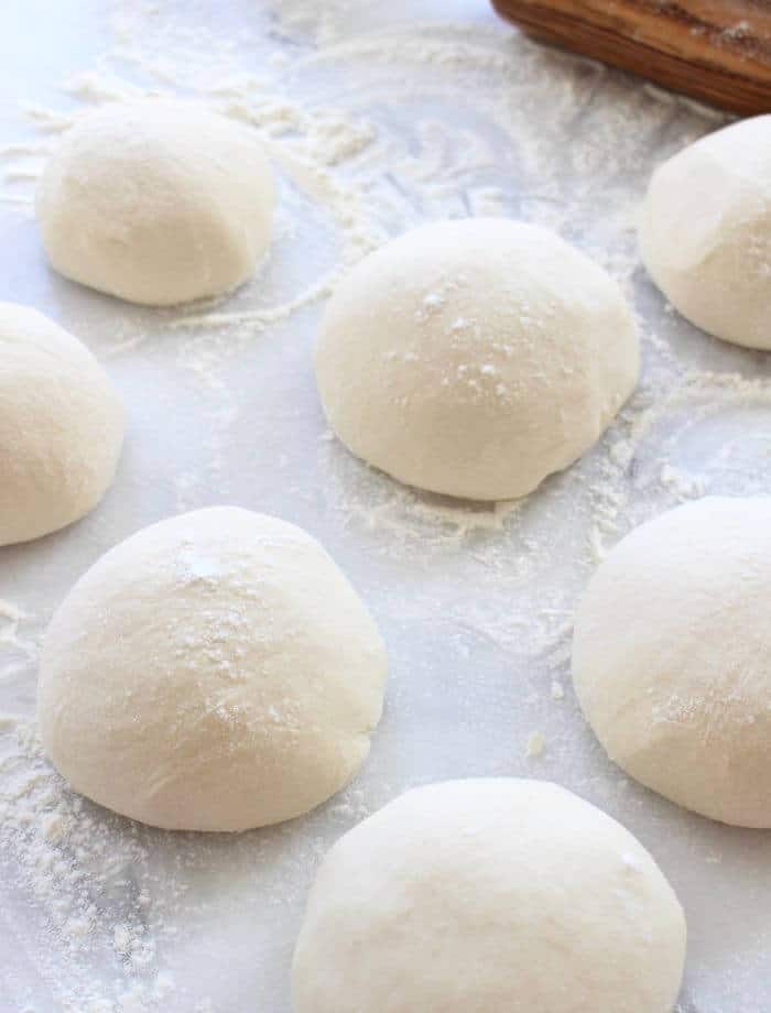Italian Pizza Dough Balls Resting on a Marble Board
