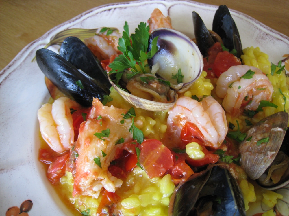 Rustic Bowl of Italian Seafood Risotto with Shrimp, Mussels, Clams and Saffron
