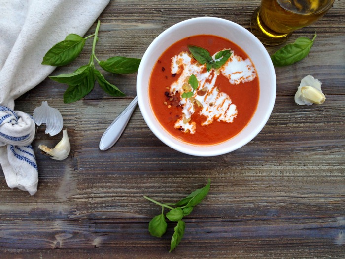 Bowl of San Marzano Tomato Soup with a Swirl of Cream and Fresh Basil