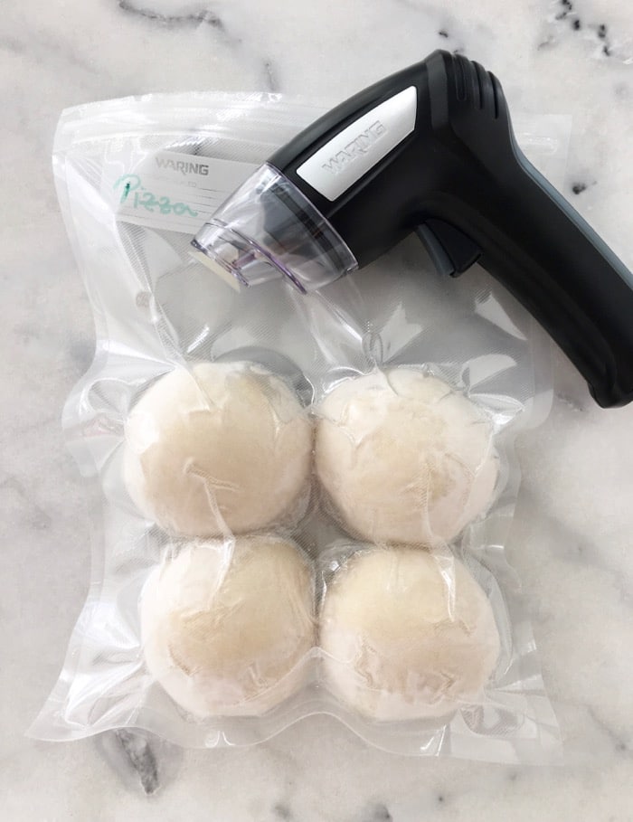 Vacuum sealed pizza dough balls for freezing