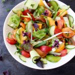 Bowl of Cucumber Tomato Salad with Scallions and Herbs