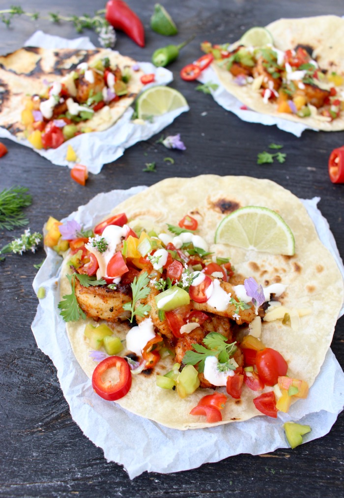 Close up of grilled Mexican Shrimp Tacos with colorful salsa fresca