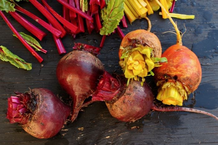 Red and Golden Beets on a Wood Table
