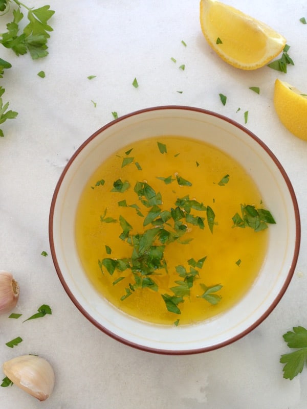 Bowl of Lemon Garlic Butter Sauce on a White Table