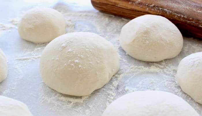 Italian Pizza Dough Balls on Pastry Board with Rolling PIn