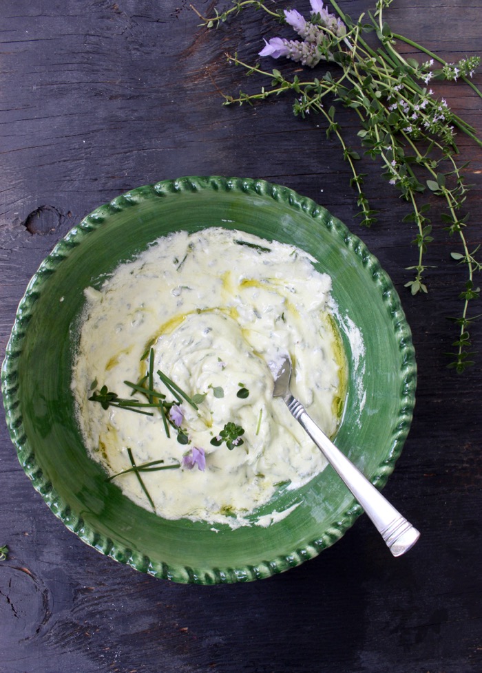 Green Bowl of Whipped Goat Cheese with Herbs on a Rustic Table