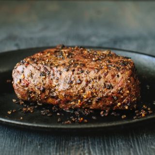 Peppercorn crusted Steak on a Cast iron Skillet