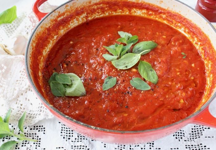 The best authentic Italian Marinara Sauce with Basil and Garlic in a Red Pot.