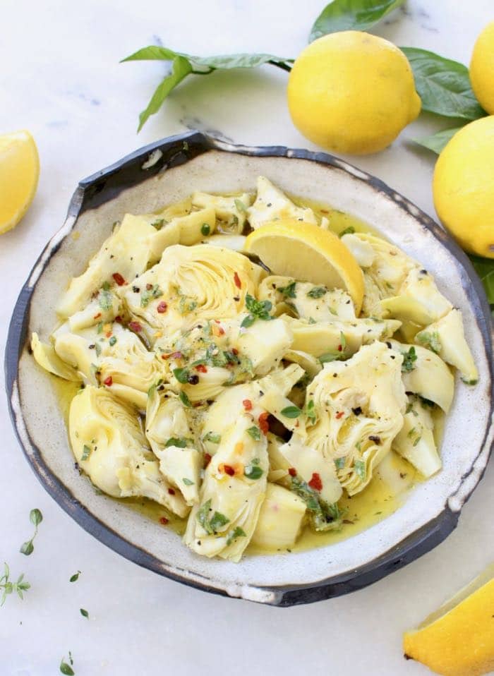 Marinated Artichoke Hearts with Olive Oil, Garlic, Lemon and Herbs in Rustic Bowl