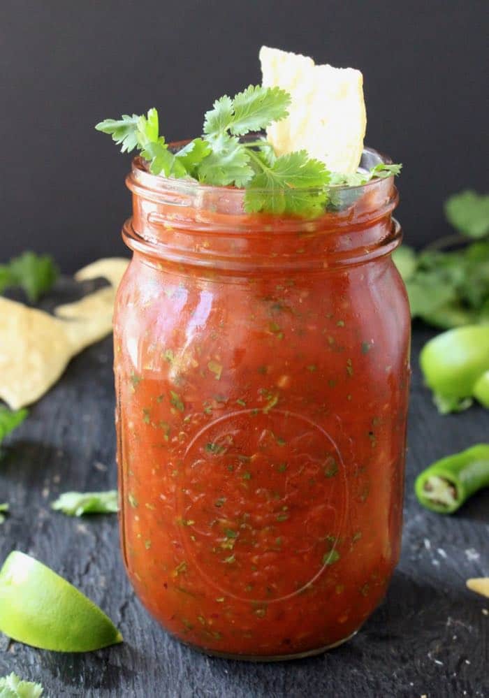 Jar of Homemade Salsa Restaurant with Cilantro and Chips