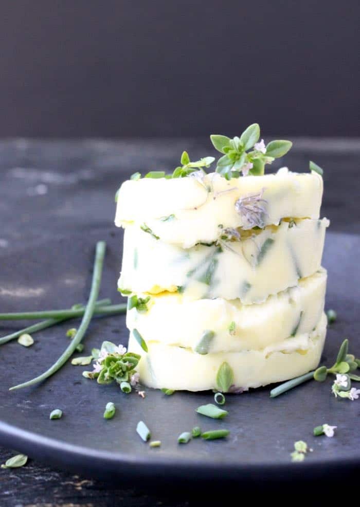 Sliced Compound Chive Butter with Chive Flowers and Garlic