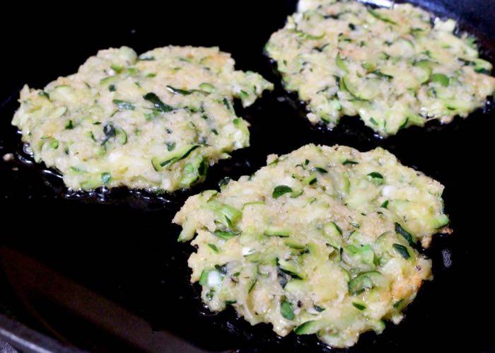 Zucchini Cakes Cooking in a Cast Iron Skillet