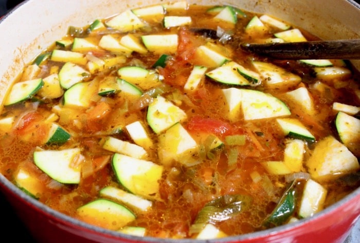 Cooking Italian vegetable soup with zucchini and farro